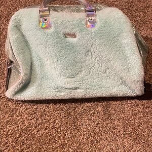 Justice turquoise Faux fur Women's Bag with wheels and extended handle.